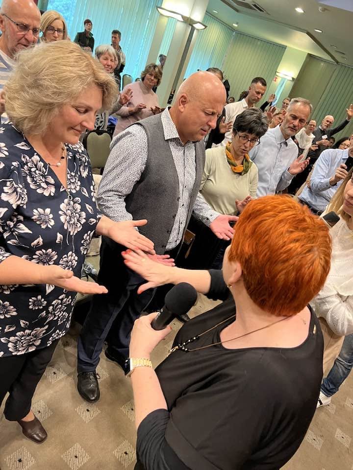 Sharon Parkes ministering to people in prayer